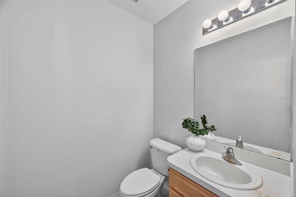 28632 Seashell Court Wesley Chapel, FL 33545 - Photo 26 of 60 a white toilet sitting next to a bathroom sink