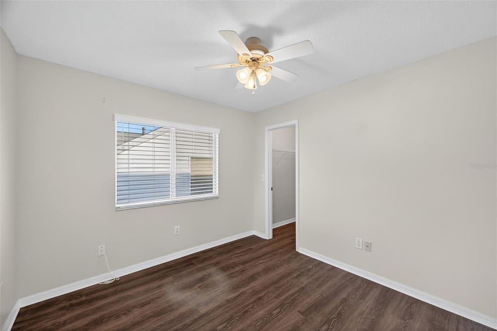 28632 Seashell Court Wesley Chapel, FL 33545 - Photo 29 of 60 a view of an empty room with wooden floor and a window
