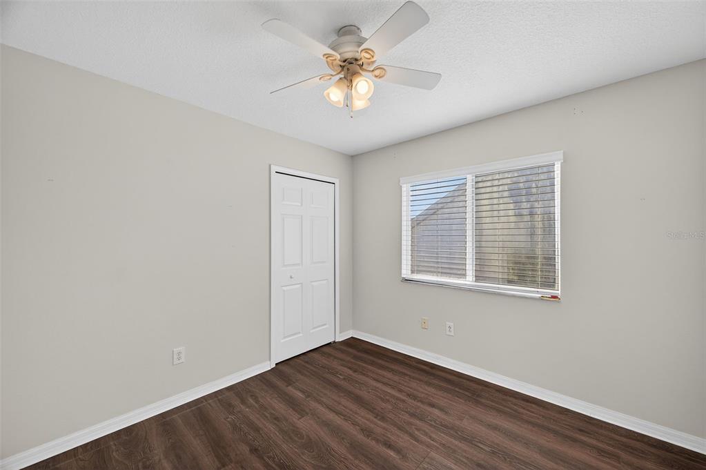 28632 Seashell Court Wesley Chapel, FL 33545 - Photo 33 of 60 a view of an empty room with a window and wooden floor