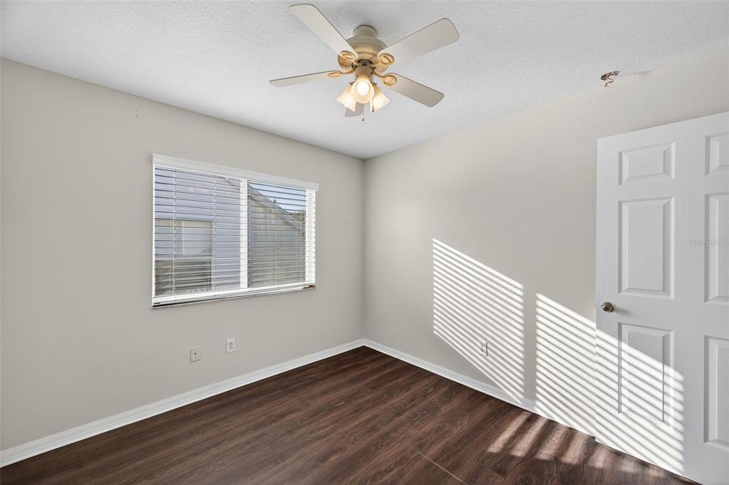 28632 Seashell Court Wesley Chapel, FL 33545 - Photo 34 of 60 a view of an empty room with a window and wooden floor
