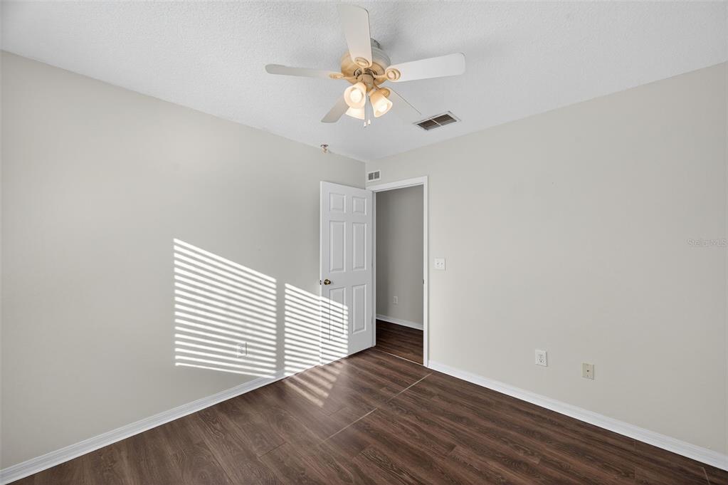 28632 Seashell Court Wesley Chapel, FL 33545 - Photo 35 of 60 a view of an empty room with wooden floor and a window