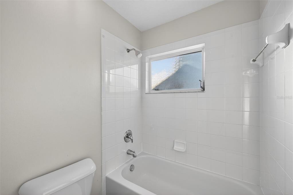 28632 Seashell Court Wesley Chapel, FL 33545 - Photo 38 of 60 a bathroom with a toilet and a bathtub