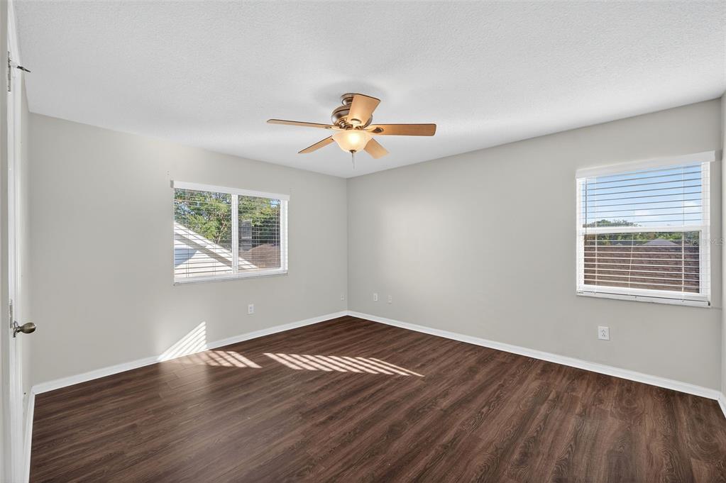 28632 Seashell Court Wesley Chapel, FL 33545 - Photo 39 of 60 a view of a room with wooden floor and a ceiling fan