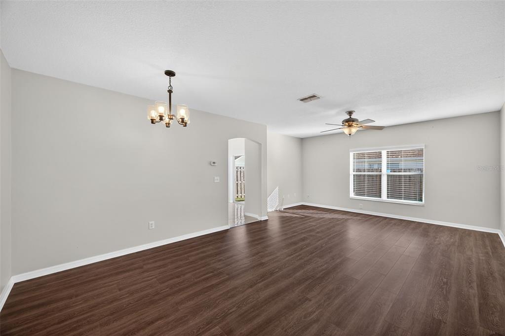 28632 Seashell Court Wesley Chapel, FL 33545 - Photo 9 of 60 a view of an empty room with wooden floor and a window