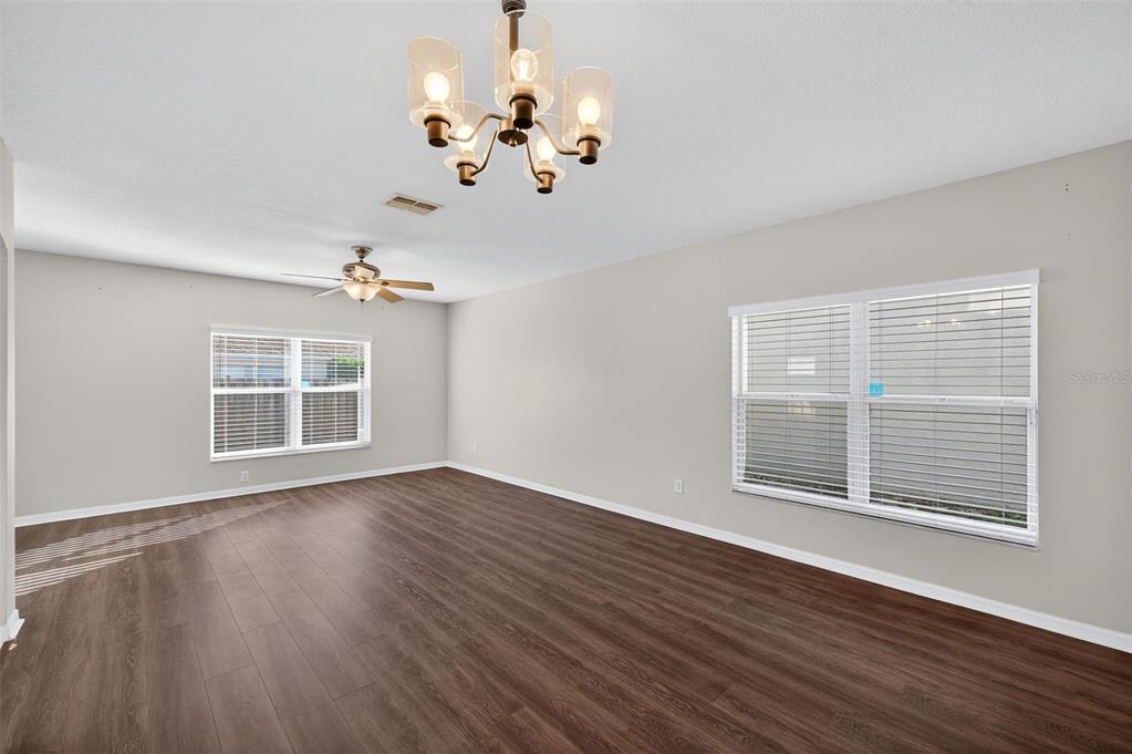 28632 Seashell Court Wesley Chapel, FL 33545 - Photo 10 of 60 a view of an empty room with wooden floor and a window