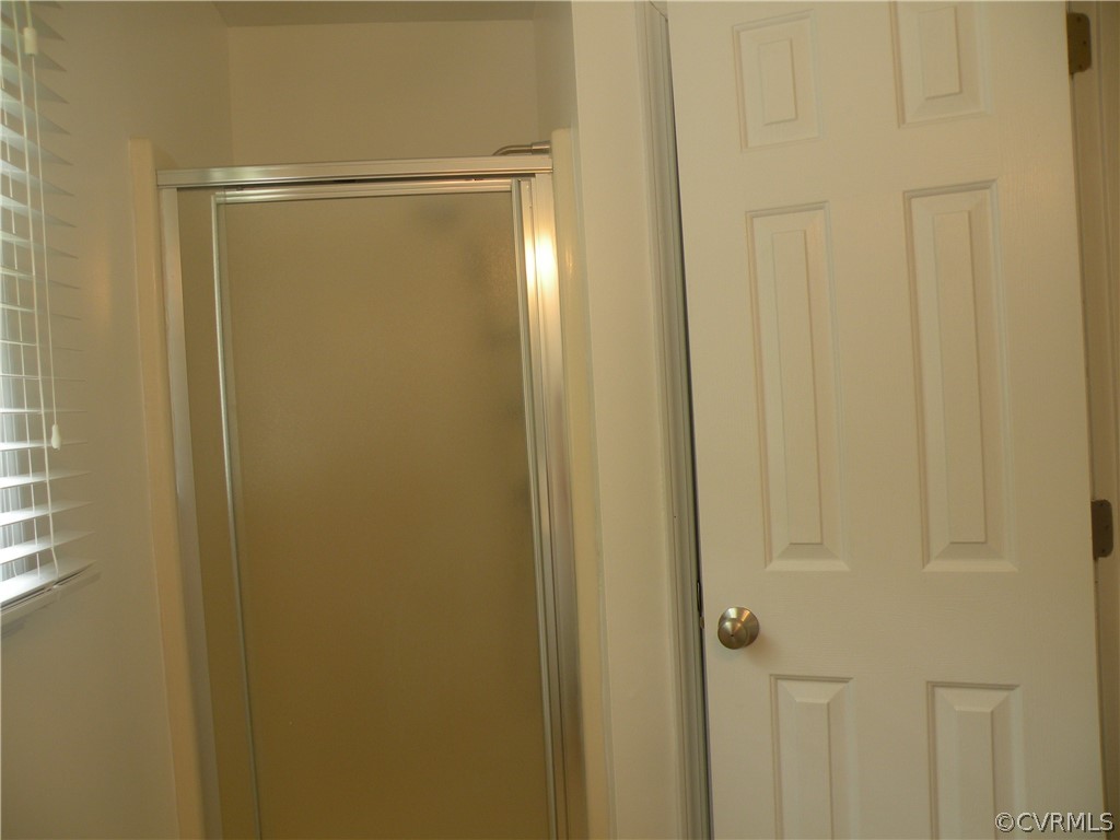 12436 Walkes Quarter Road Chesterfield, VA 23838 - Photo 23 of 31 a bathroom with a glass shower door