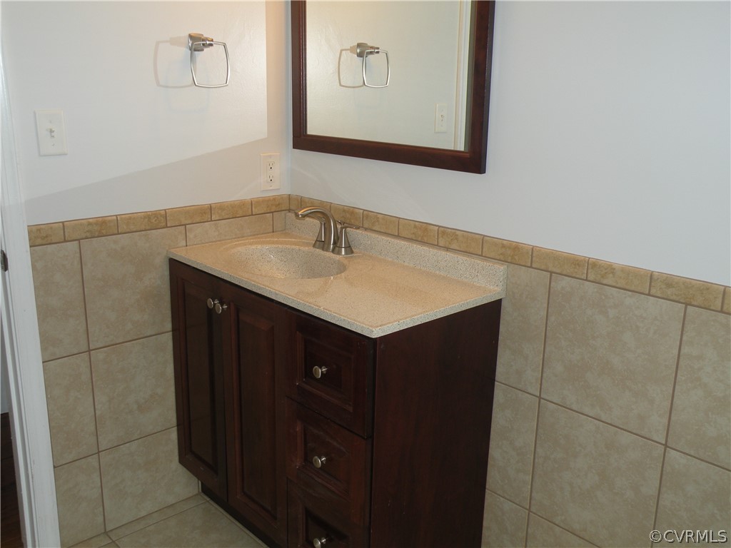 12436 Walkes Quarter Road Chesterfield, VA 23838 - Photo 9 of 31 a bathroom with a sink vanity and mirror