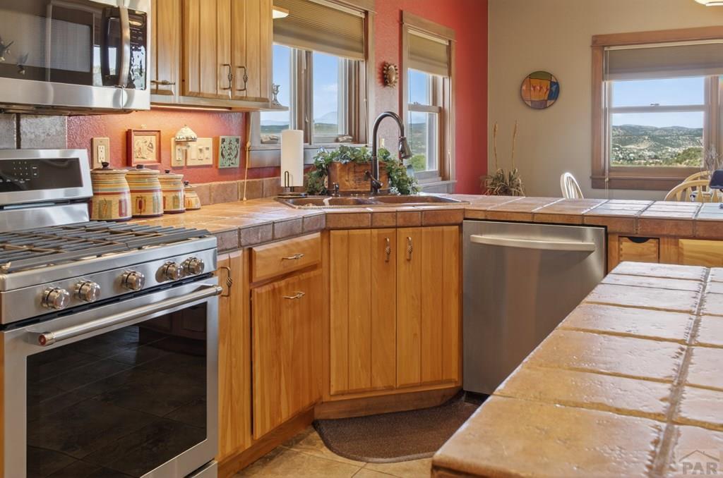 415 Riata Drive Trinidad, CO 81082 - Photo 31 of 61 a kitchen with stainless steel appliances granite countertop a stove and a sink
