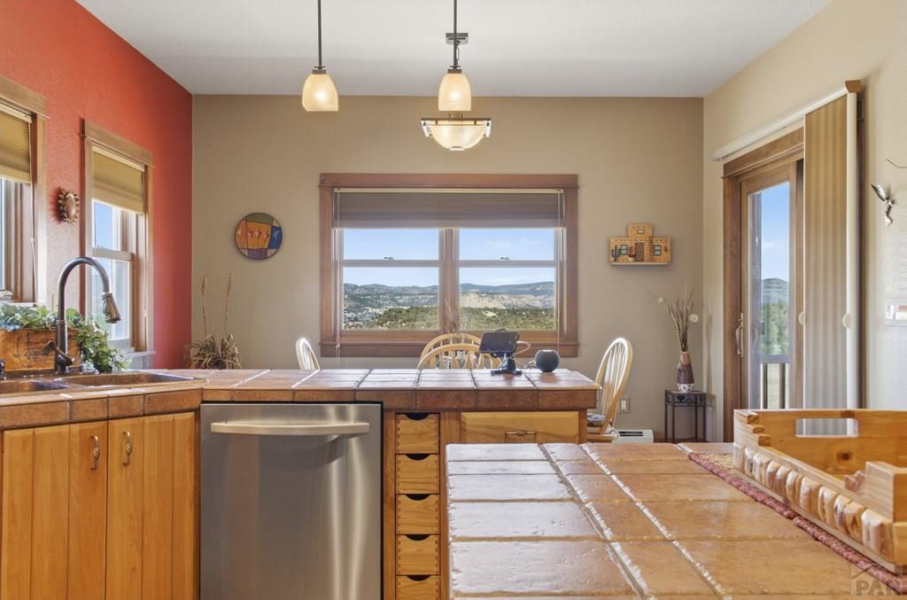 415 Riata Drive Trinidad, CO 81082 - Photo 34 of 61 a dining hall with stainless steel appliances granite countertop a sink dishwasher a fireplace with wooden floor