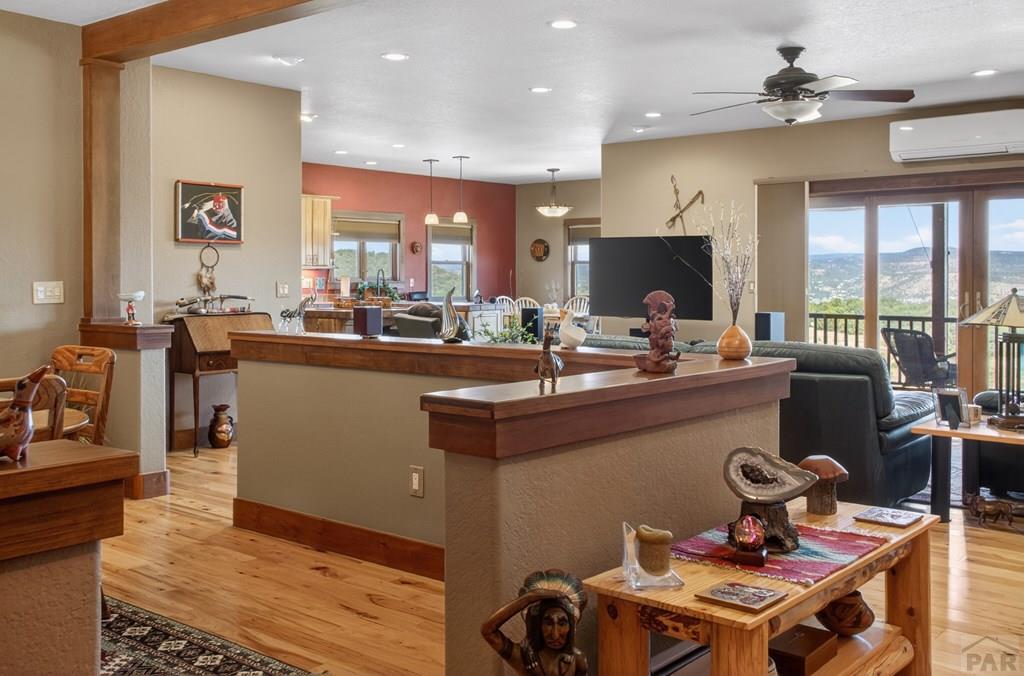 415 Riata Drive Trinidad, CO 81082 - Photo 53 of 61 a kitchen with a stove a refrigerator and a dining table with wooden floor