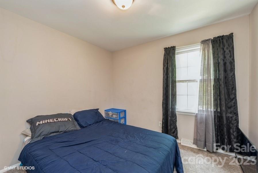6925 Random Place Charlotte, NC 28215 - Photo 16 of 31 a bedroom with a bed and a window