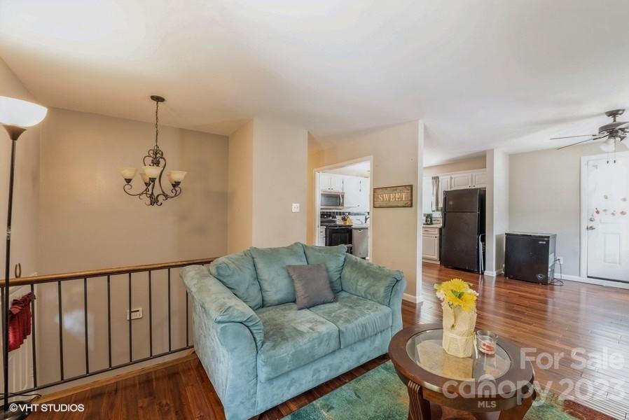6925 Random Place Charlotte, NC 28215 - Photo 6 of 31 a living room with furniture kitchen view and a chandelier