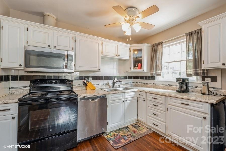6925 Random Place Charlotte, NC 28215 - Photo 9 of 31 a kitchen with stainless steel appliances a stove a sink and cabinets