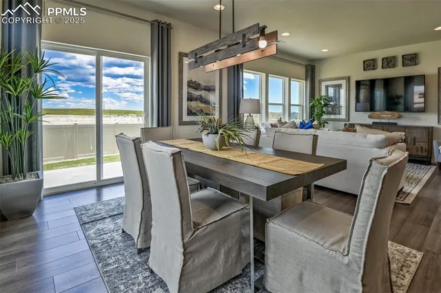 a view of a dining room with furniture window and wooden floor