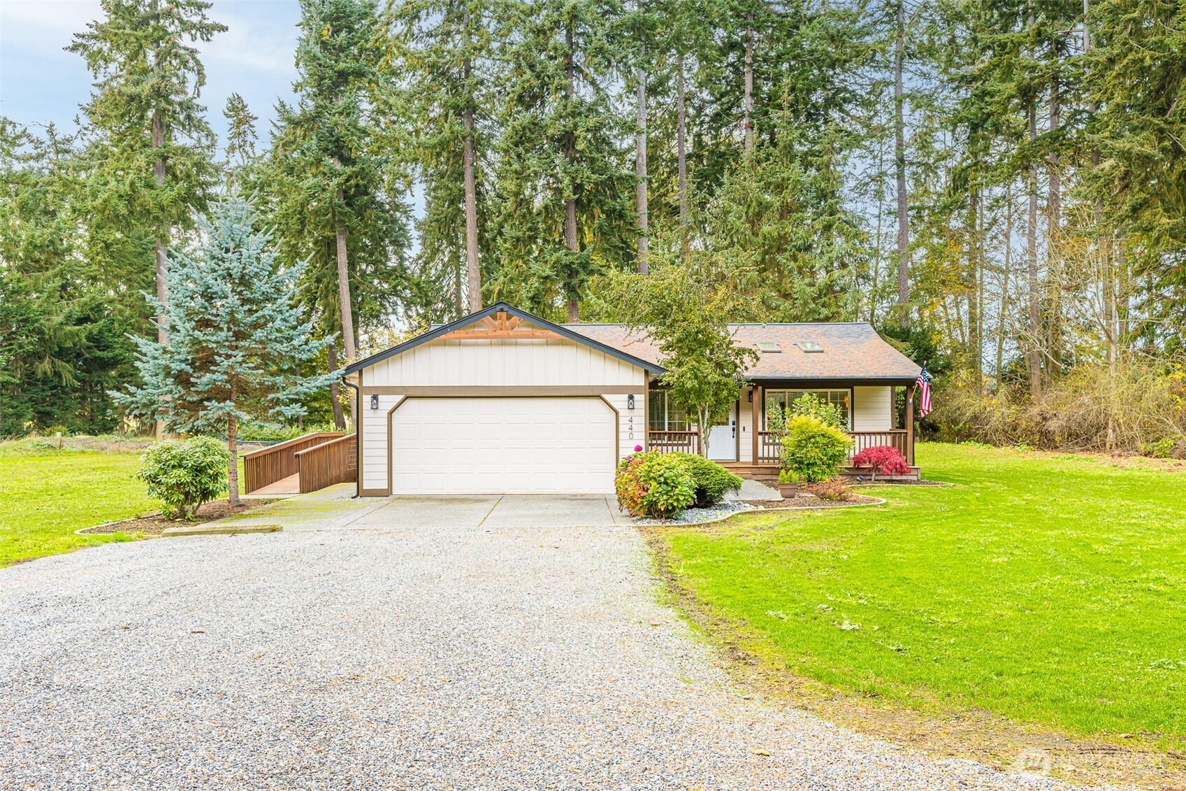 a view of a house with a yard and sitting area