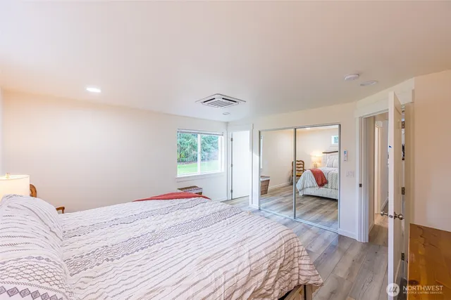 a bedroom with a bed and a large window