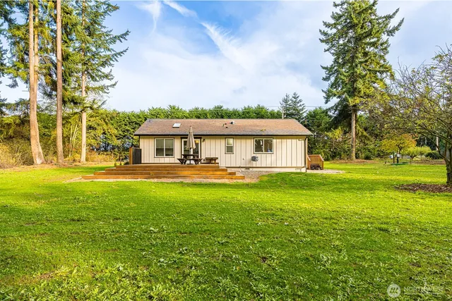 a front view of a house with yard and green space