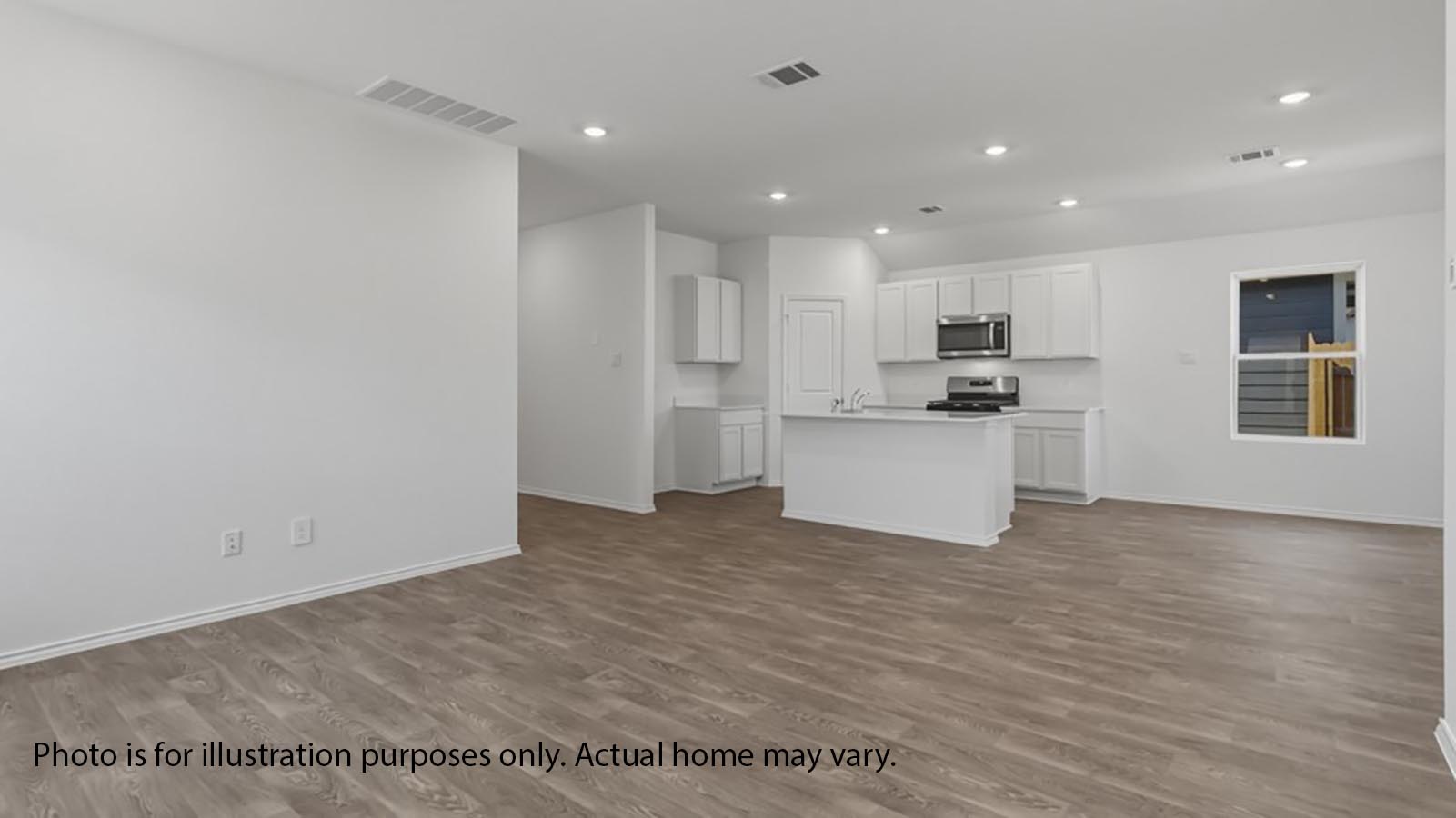 1205 Celosia Loop Kyle, TX 78640 - Photo 7 of 25 a view of a kitchen with a stove cabinets and a wooden floor