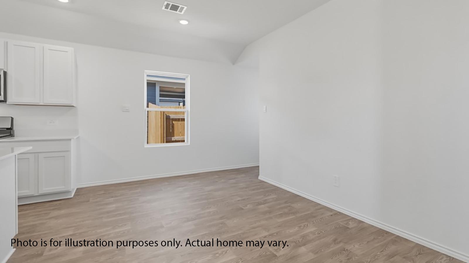 1205 Celosia Loop Kyle, TX 78640 - Photo 9 of 25 an empty room with wooden floor and windows