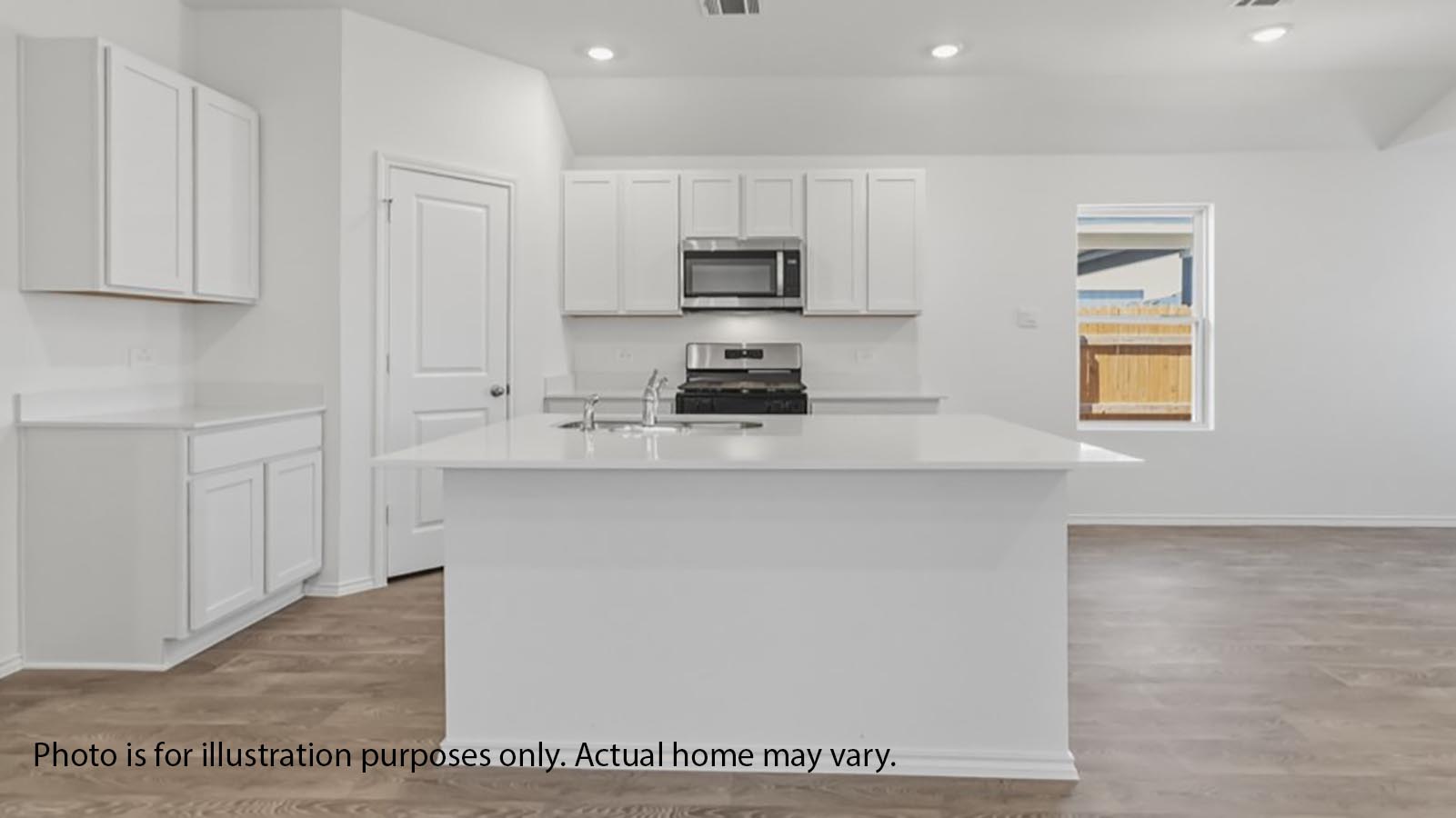 1205 Celosia Loop Kyle, TX 78640 - Photo 10 of 25 a kitchen with stainless steel appliances granite countertop a stove a sink and a microwave
