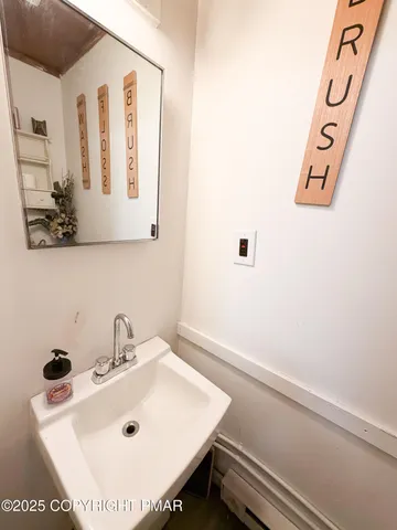a bathroom with a sink and mirror