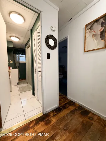 a view of an entryway with wooden floor