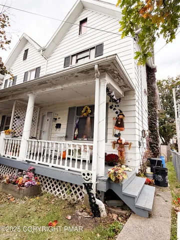 a view of a house with a large tree