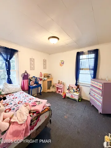 a bedroom with bed and window