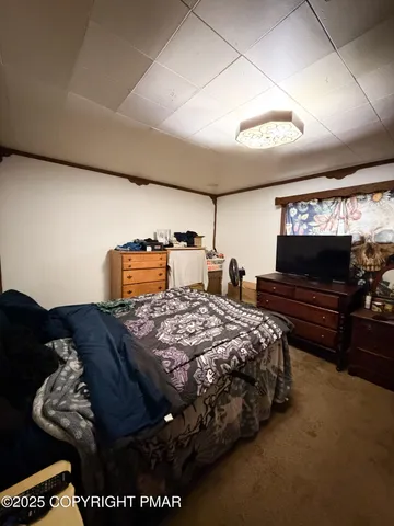 a bedroom with bed and window