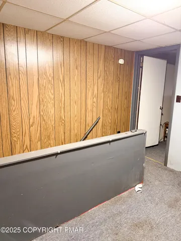 a view of a room with a window and a ceiling fan