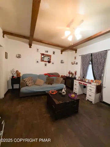 a bedroom with furniture and a wooden floor