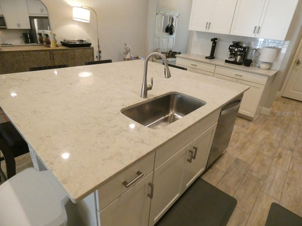 1505 Sunset Wind Loop Oldsmar, FL 34677 - Photo 11 of 36 a kitchen with stainless steel appliances a sink a stove and a microwave