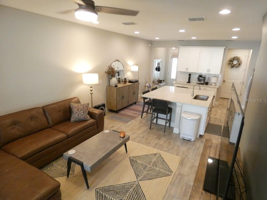 1505 Sunset Wind Loop Oldsmar, FL 34677 - Photo 19 of 36 a living room with furniture a dining table and kitchen view