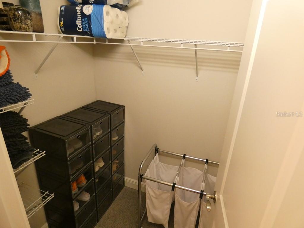 1505 Sunset Wind Loop Oldsmar, FL 34677 - Photo 23 of 36 a view of walk in closet with clothes and shoes