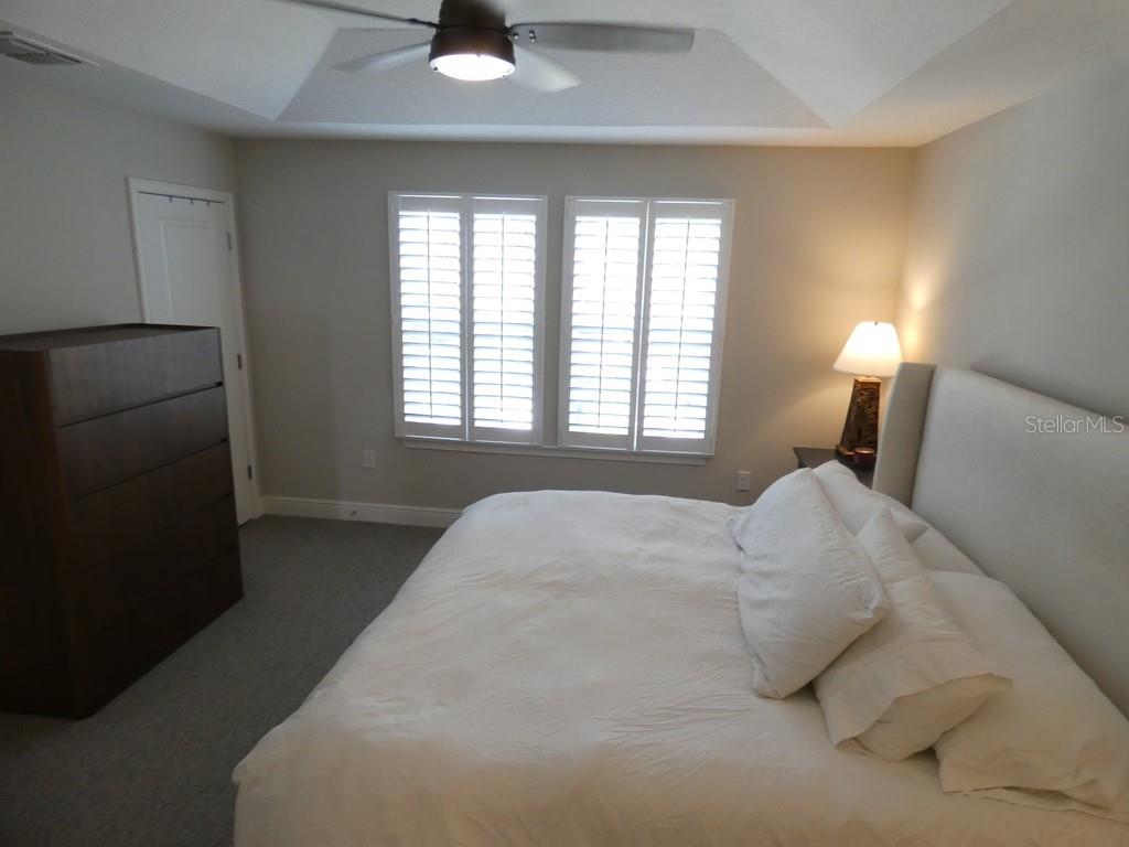 1505 Sunset Wind Loop Oldsmar, FL 34677 - Photo 24 of 36 a bedroom with a bed and a lamp with window