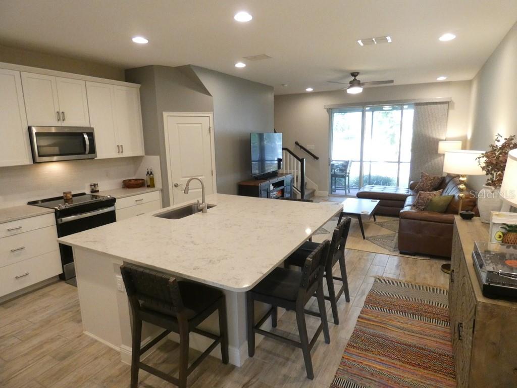 1505 Sunset Wind Loop Oldsmar, FL 34677 - Photo 5 of 36 a large kitchen with kitchen island a large island in the center