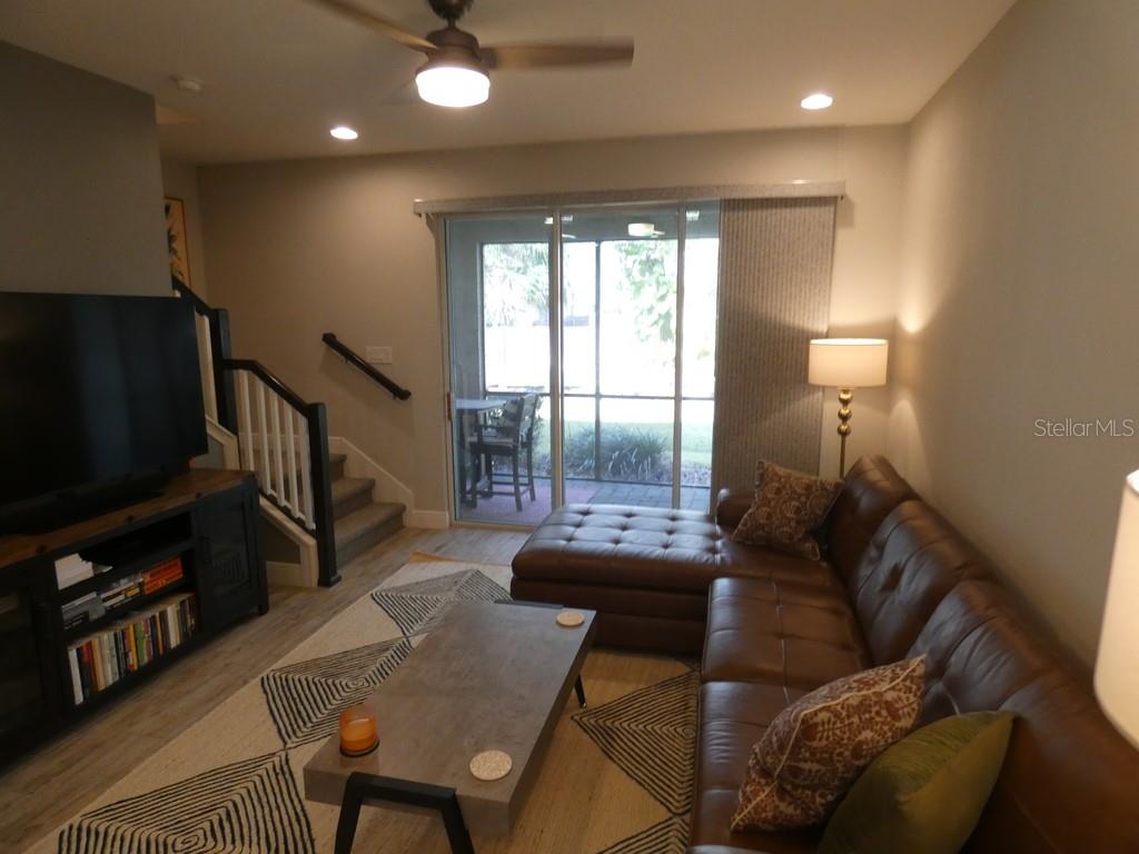 1505 Sunset Wind Loop Oldsmar, FL 34677 - Photo 9 of 36 a living room with furniture and a flat screen tv