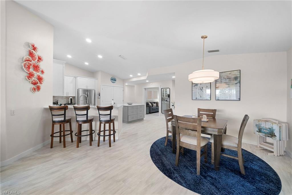 9231 Spring Run Boulevard, Unit 2109 Estero, FL 34135 - Photo 4 of 35 Dining space with light wood-style floors, lofted ceiling, and recessed lighting