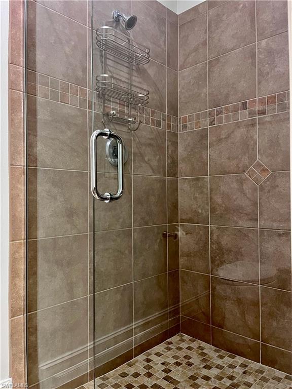 9092 Chula Vista Street, Unit 11003 Naples, FL 34113 - Photo 11 of 42 a bathroom with a shower