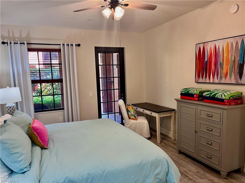 9092 Chula Vista Street, Unit 11003 Naples, FL 34113 - Photo 15 of 42 a bed room with a bed and a dresser
