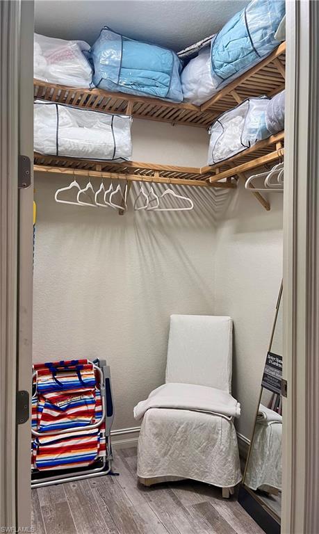 9092 Chula Vista Street, Unit 11003 Naples, FL 34113 - Photo 17 of 42 a bedroom with a bunk bed and a dresser