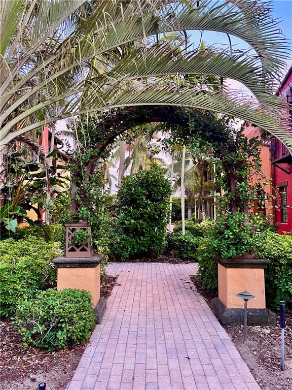 9092 Chula Vista Street, Unit 11003 Naples, FL 34113 - Photo 24 of 42 a view of outdoor space deck and tree