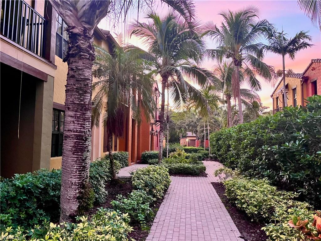 9092 Chula Vista Street, Unit 11003 Naples, FL 34113 - Photo 25 of 42 a view of a pathway with house on both side