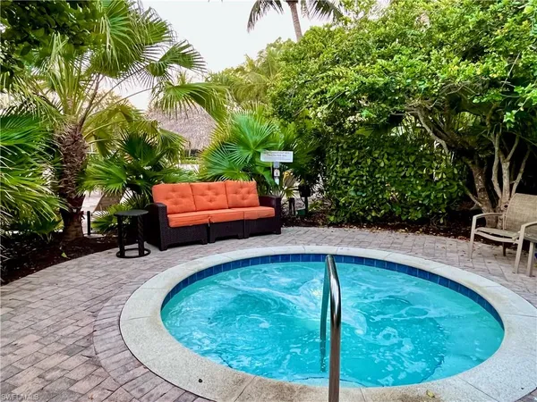 a swimming pool with outdoor seating and yard