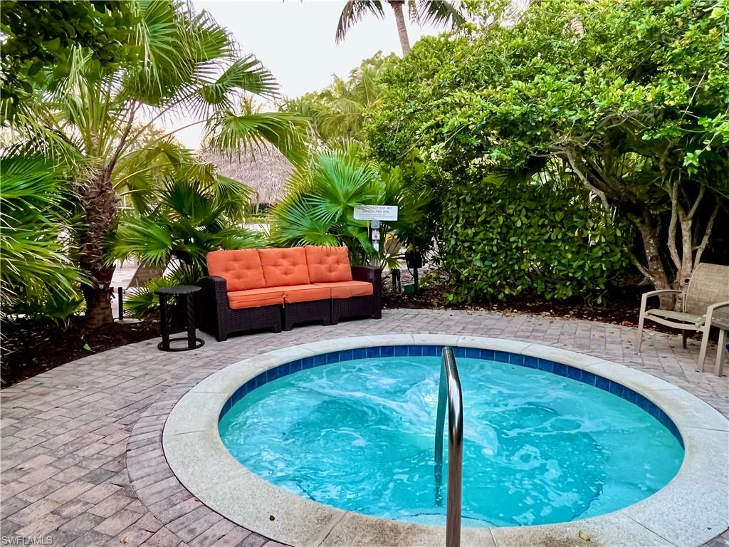 9092 Chula Vista Street, Unit 11003 Naples, FL 34113 - Photo 29 of 42 a view of a swimming pool with a outdoor seating
