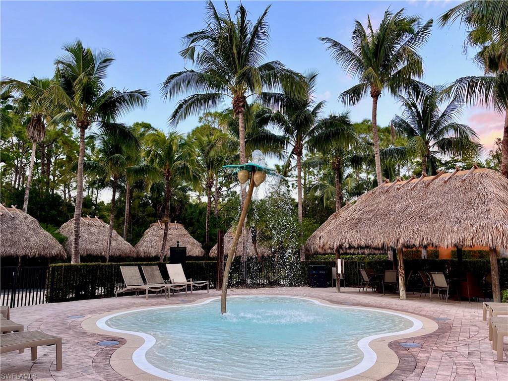 9092 Chula Vista Street, Unit 11003 Naples, FL 34113 - Photo 30 of 42 a swimming pool with outdoor seating and yard