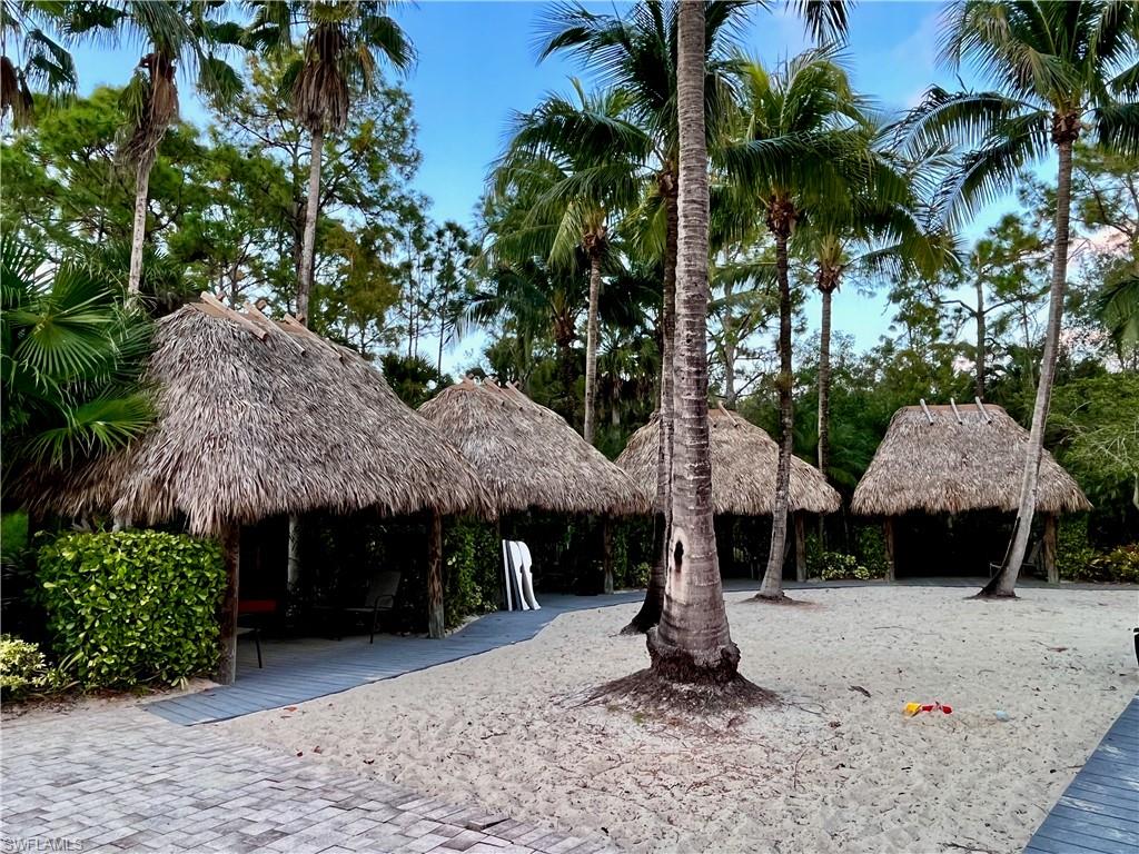 9092 Chula Vista Street, Unit 11003 Naples, FL 34113 - Photo 31 of 42 a front view of a house with yard and trees