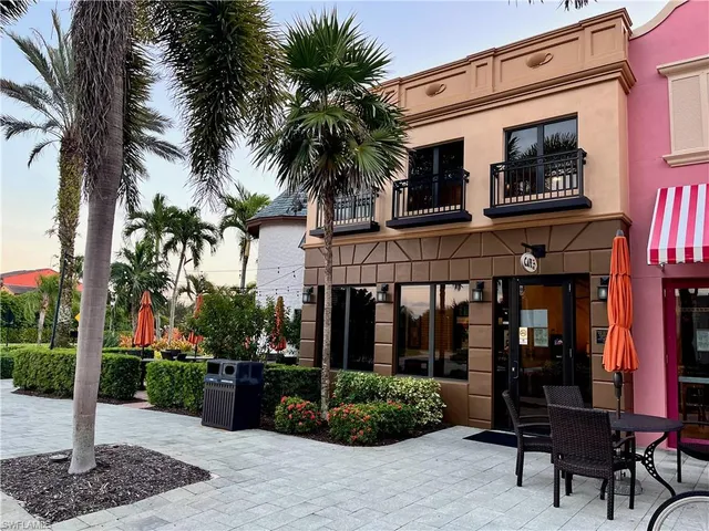 a living room with furniture a rug and a book shelf