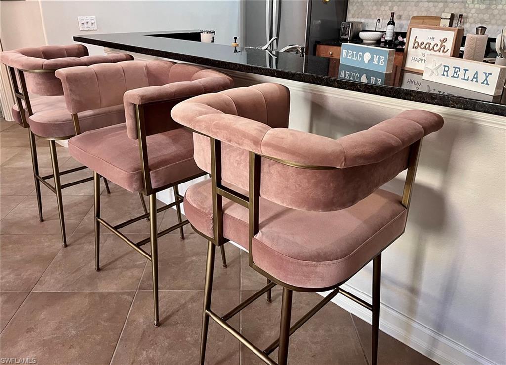 9092 Chula Vista Street, Unit 11003 Naples, FL 34113 - Photo 5 of 42 a living room with furniture and a rug