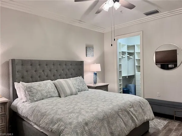 a bedroom with a bed and a chandelier
